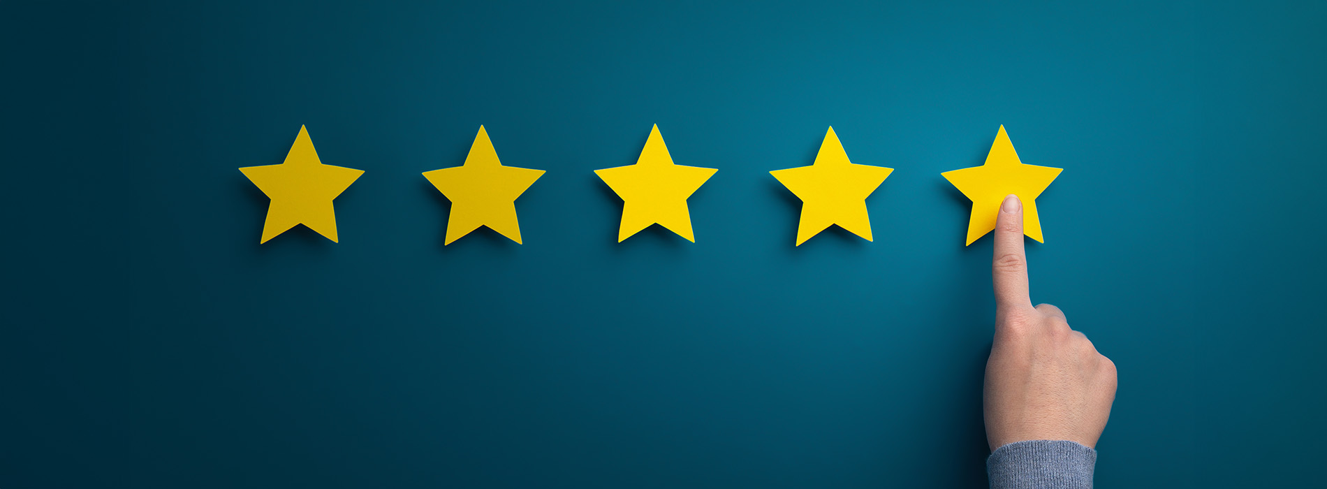 The image features a graphic with a blue background displaying a stylized star shape next to a hand pointing at it, suggesting excellence or high rating, within a darker border that resembles a wall or panel.